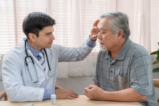 Doctor examining the eye of senior patient