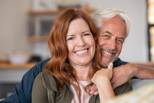 Happy middle age couple in their home