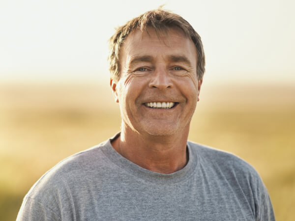 man standing outdoors in a natural landscape